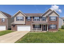 Charming two-story home featuring a brick facade, attached two-car garage, and well-maintained front lawn at 3624 Newberry Rd, Plainfield, IN 46168