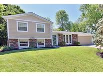 Charming two-story home with a brick facade and a well-manicured lawn at 524 Concord Ct, Fishers, IN 46038