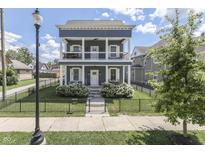 Charming two-story home with a double-decker porch, fenced yard, and manicured landscaping at 847 E Jefferson St, Franklin, IN 46131