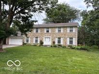 Charming two-story home with stone facade and well-manicured lawn at 10720 Lakeview Dr, Carmel, IN 46033