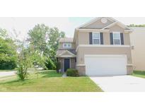 Charming two-story home featuring tan siding, a two-car garage, and a well-maintained front lawn at 11445 Congaree Way, Indianapolis, IN 46235