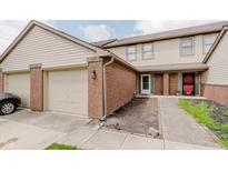Exterior view of a brick and vinyl siding home with a one car garage and red front door at 5370 Bay Harbor Dr, Indianapolis, IN 46254