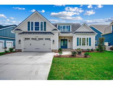 Charming two-story home with a well-manicured lawn, white siding, and a two-car garage at 5146 Middleton View Dr., Myrtle Beach, SC 29579