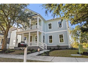 Charming two-story home with a light blue exterior and double front porches at 1604 James Island Ave., North Myrtle Beach, SC 29582
