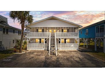 Two-story beach house with white siding, multiple balconies, and a central staircase at 206 31St Ave. N, North Myrtle Beach, SC 29582