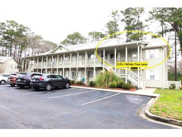 Inviting two-story condo with well-maintained landscaping and convenient parking at 1131 White Tree Ln. # 31-J, Myrtle Beach, SC 29588