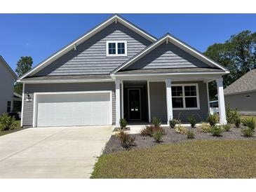 Charming single-Gathering home featuring a welcoming front porch and a two-car garage with beautiful lawn at 116 Fair Meadow Ct., Loris, SC 29569