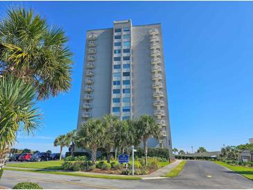 Exterior view of a high-rise condo building, landscaped grounds, and a blue sky backdrop at 9820 Queensway Blvd. # 501, Myrtle Beach, SC 29572