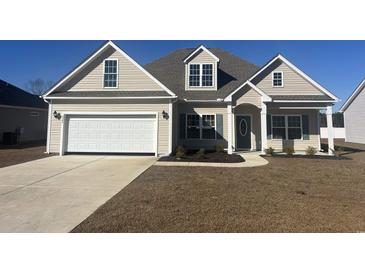 New construction home with a two-car garage and landscaping at 2347 King Farm Rd., Aynor, SC 29511