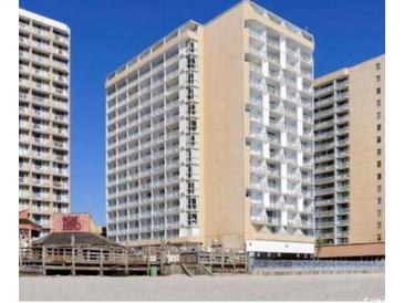 View of a high rise condo building on the beach featuring private balconies and a blue sky at 9550 Shore Dr. # 925, Myrtle Beach, SC 29572