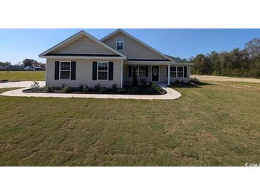 Charming one-story home with manicured lawn and inviting front porch at Tbd 16 Privetts Rd., Conway, SC 29526