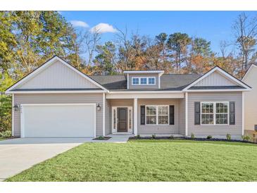 New construction home with gray siding, two-car garage, and a well-manicured lawn at 4414 Kinlaw St., Little River, SC 29566