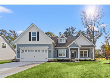 Charming single-Gathering home with blue siding, white trim, and a well-manicured front lawn at 639 Carter Reid Ct., Longs, SC 29568