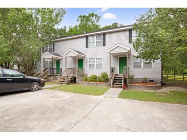 Three-unit building with green doors, steps, and parking at 2201 John Henry Ln., Myrtle Beach, SC 29579