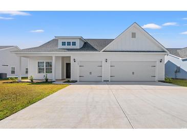 White two-story house with three car garage and landscaped yard at 1133 Cypress Shoal Dr., Conway, SC 29526