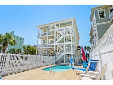 Inviting pool area with lounge chairs, and a view of the building at 5207 Ocean Blvd. N, North Myrtle Beach, SC 29582