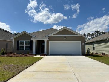 Charming single-story home featuring a two-car garage and neatly maintained front lawn at 90 Arbor Crest Ln., Tabor City, NC 28463