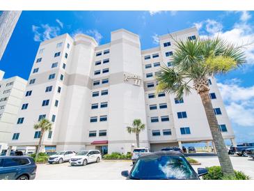 Stunning exterior view of a multi-story condo building with palm trees in front at 5800 N Ocean Blvd. # 705, North Myrtle Beach, SC 29582