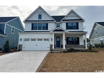 Two-story house with white siding, brick accents, and a two-car garage at 2317 Hazel Way, Longs, SC 29568