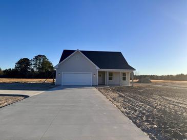 Newly constructed home with a paved driveway and a two-car garage at 882 Liberty Church Rd., Loris, SC 29569