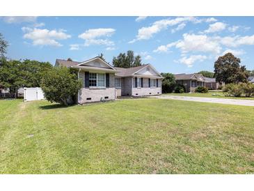 Charming single story home with large front yard and traditional brick exterior at 9138 Wildwood Pl., Murrells Inlet, SC 29576