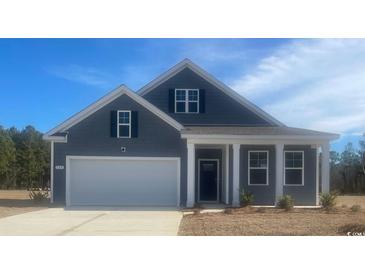 Gray two-story house with white columns and a two-car garage at 120 Pampa Dr., Loris, SC 29569