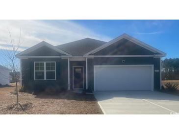 Gray house with white garage door and landscaping at 149 Pampa Dr., Loris, SC 29569