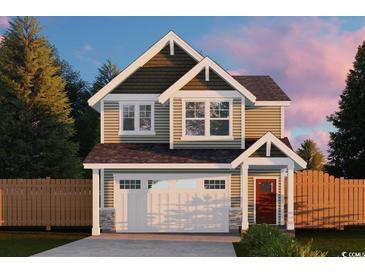 Two-story Craftsman home with a large garage and wood fence at Tbb 129 Charles Towne Ln., Murrells Inlet, SC 29576