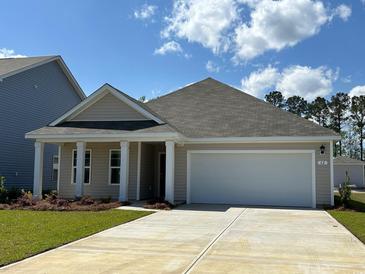 Charming single-story home features a two-car garage and well-maintained landscaping at 62 Arbor Crest Ln., Tabor City, NC 28463