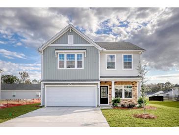 Charming two-story home featuring a two-car garage and a well-manicured lawn at 126 Hancher Dr., Myrtle Beach, SC 29588