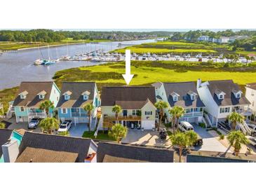 Beautiful elevated home with a deck overlooking a tranquil waterway and marina in a coastal community at 4524 Landing Rd., Little River, SC 29566