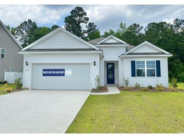 Charming single-story home with white siding, blue door, and well-manicured lawn. MOVE IN NOW! at 368 Clear Lake Dr., Conway, SC 29526