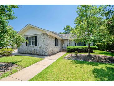 Brick ranch home with landscaped yard and walkway at 1492 Fox Hollow Way, North Myrtle Beach, SC 29582