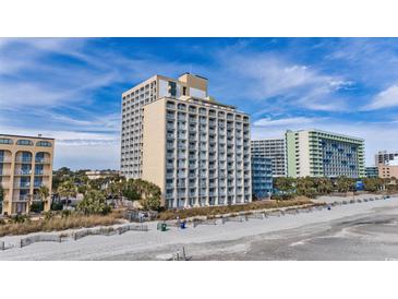 Coastal condo building featuring multiple floors, each with private balconies, overlooking a sandy beach at 1207 S Ocean Blvd. # 20808, Myrtle Beach, SC 29577