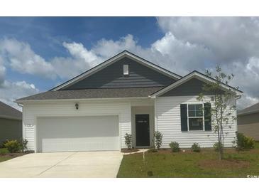Charming one-story home with a well-maintained lawn and attached two-car garage and blue and white siding at 206 Hadley Springs Ave, Longs, SC 29568