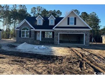 New construction home with stone and shingle exterior, two-car garage, and large windows at 2260 Pearl Rd., Galivants Ferry, SC 29544