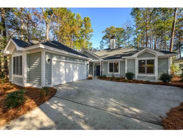 Gray house with two-car garage and nicely landscaped yard at 1237 Clipper Rd., North Myrtle Beach, SC 29582