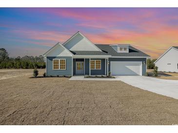 Newly constructed home with gray siding, white accents, and a two-car garage at 112 Infinity Ln., Loris, SC 29569