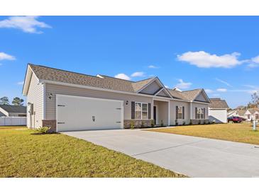 Newly constructed home with attached two-car garage and manicured lawn at 328 Lakota Loop, Longs, SC 29568