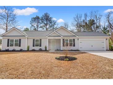 Charming single-story home featuring a well-manicured front yard, attached garage, and beautiful curb appeal at 328 Lakota Loop, Longs, SC 29568