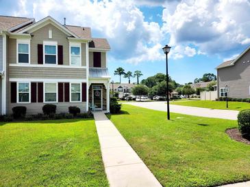 Charming home exterior with manicured lawn, sidewalk, and neutral siding at 516 Papyrus Circle # 516, Little River, SC 29566
