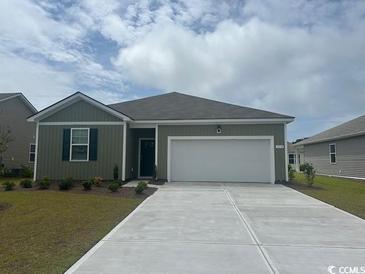 Charming single-story home showcasing a well-manicured lawn, a two-car garage and neutral-toned exterior paint at 318 Cheerful Way, Little River, SC 29566