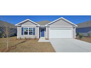 Two-story Craftsman home with a front porch and attached garage at 3851 Lady Bug Dr., Shallotte, NC 28470