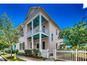 Charming two-story home featuring a welcoming porch and a classic white picket fence at 1348 Peterson St., Myrtle Beach, SC 29577