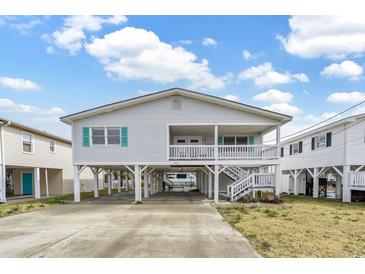 Charming raised beach house with covered parking and inviting porch at 404 32Nd Ave. N, North Myrtle Beach, SC 29582