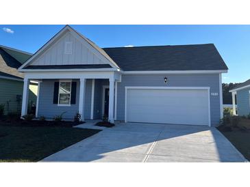 Charming single-story home with a two-car garage and a welcoming front porch at 551 Duvall St., Longs, SC 29568