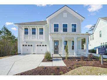 Charming two-story home with a welcoming front porch and a two-car garage at 1035 Milford Way, Myrtle Beach, SC 29588