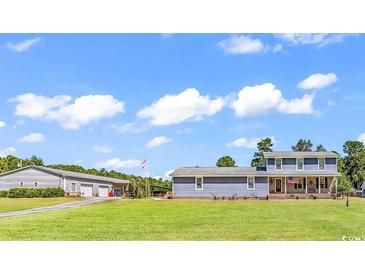 Inviting two-story home with a manicured lawn and plenty of parking space on a sunny day at 3747 Bakers Chapel Rd., Aynor, SC 29511
