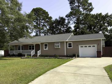 Charming home featuring a well-manicured lawn, front porch and an attached garage at 104 Sprucewood Ct., Myrtle Beach, SC 29588