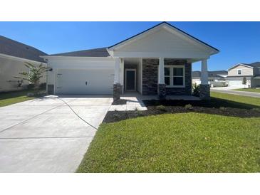 Charming single-story home with stone accents, a two-car garage, and a beautifully manicured lawn at 5026 Valley Falls St., Myrtle Beach, SC 29579